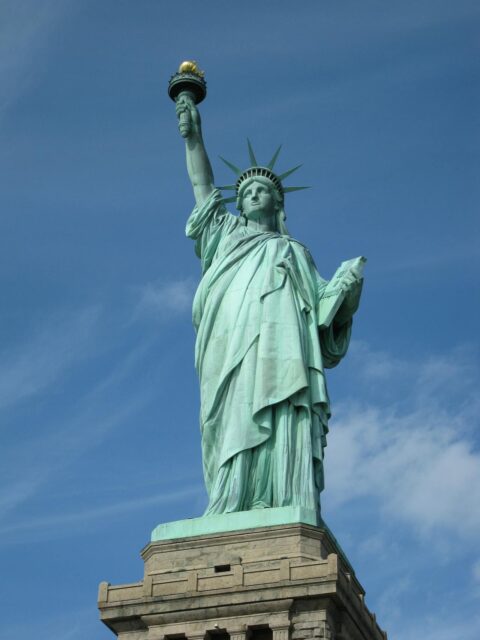 Best Places to Travel in the United States: Statue of Liberty with a clear blue sky in the background.