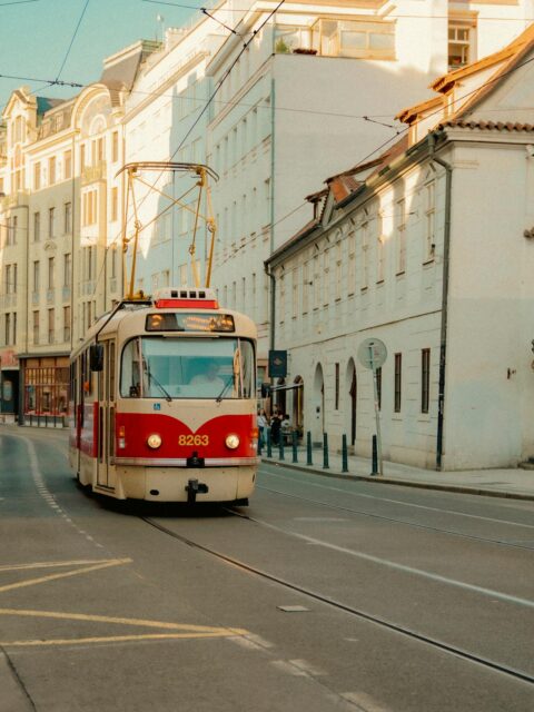 Best Things to Do in Prague, Czech Republic: A striking red tram on the streets of Prague, a unique and iconic mode of transport.