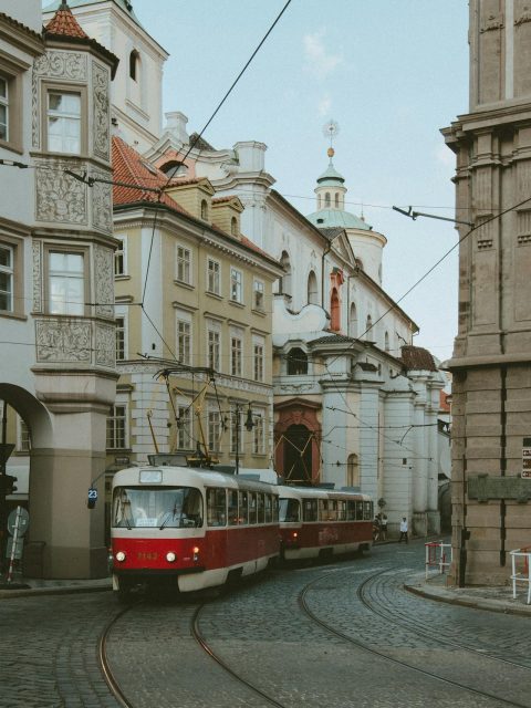 Czech Republic travel itinerary: Red tram moving through the streets of Prague, Czechia