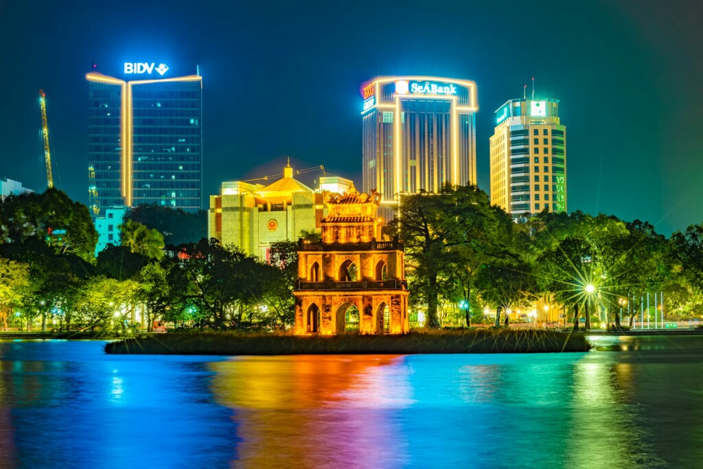 Hanoi travel guide: Hoan Kiem Lake at night, illuminated by city lights