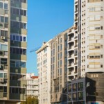 Portugal Travel Essentials: street view in Lisbon with high-rise buildings and an airplane overhead