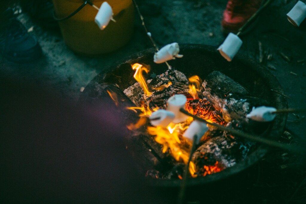 Marshmallows roasting over an open campfire, creating a cozy and delicious outdoor experience—ideal for those looking for healthy camping meals and campfire-friendly snacks.